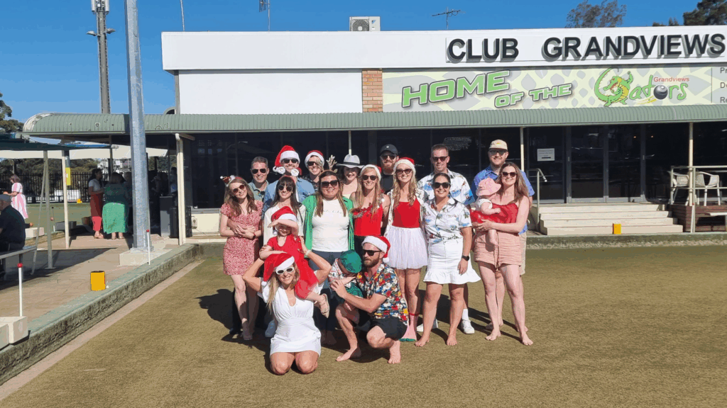Group of people enjoying a game of barefoot bowls.